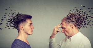 Two men looking at each other, one holding his head, depicting memory loss