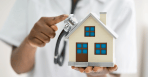 Carer holding a house in their hands, showing domiciliary care in the image