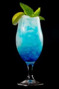 YOURmeds blue lagoon mocktail with ice and mint leaves