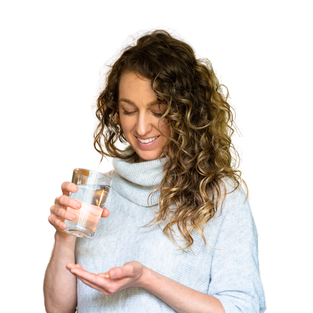 Happy lady holding medication with a glass of water