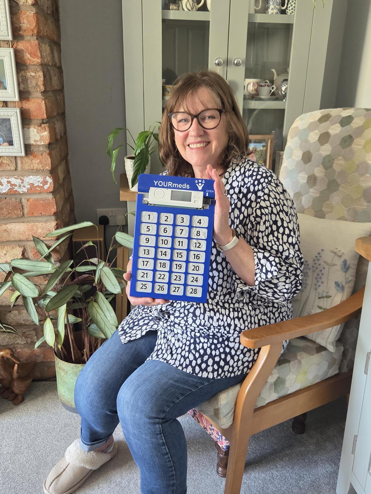 Rosheen happy lady holding yourmeds device